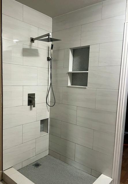 White tile walk-in shower with two niches