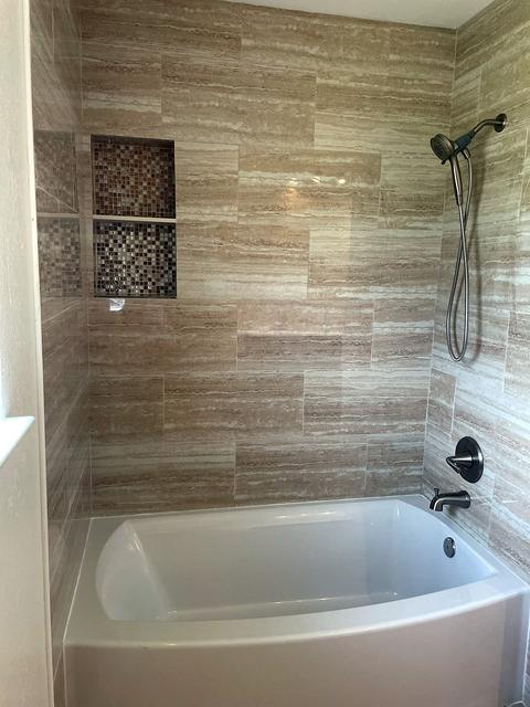 Tile tub surround with mosaic niche in Willow Park