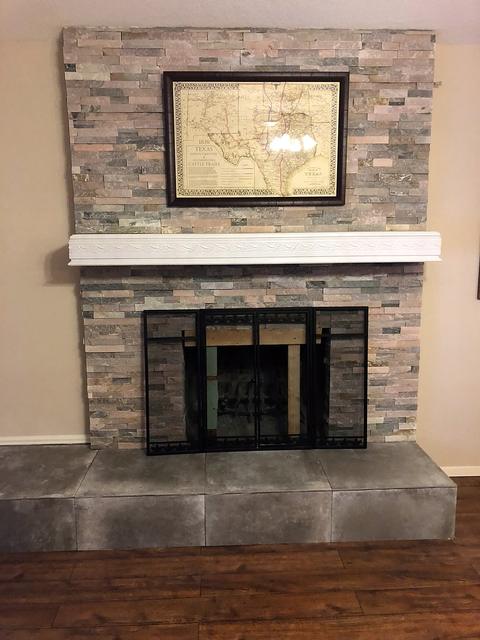 Stacked stone fireplace with tile hearth